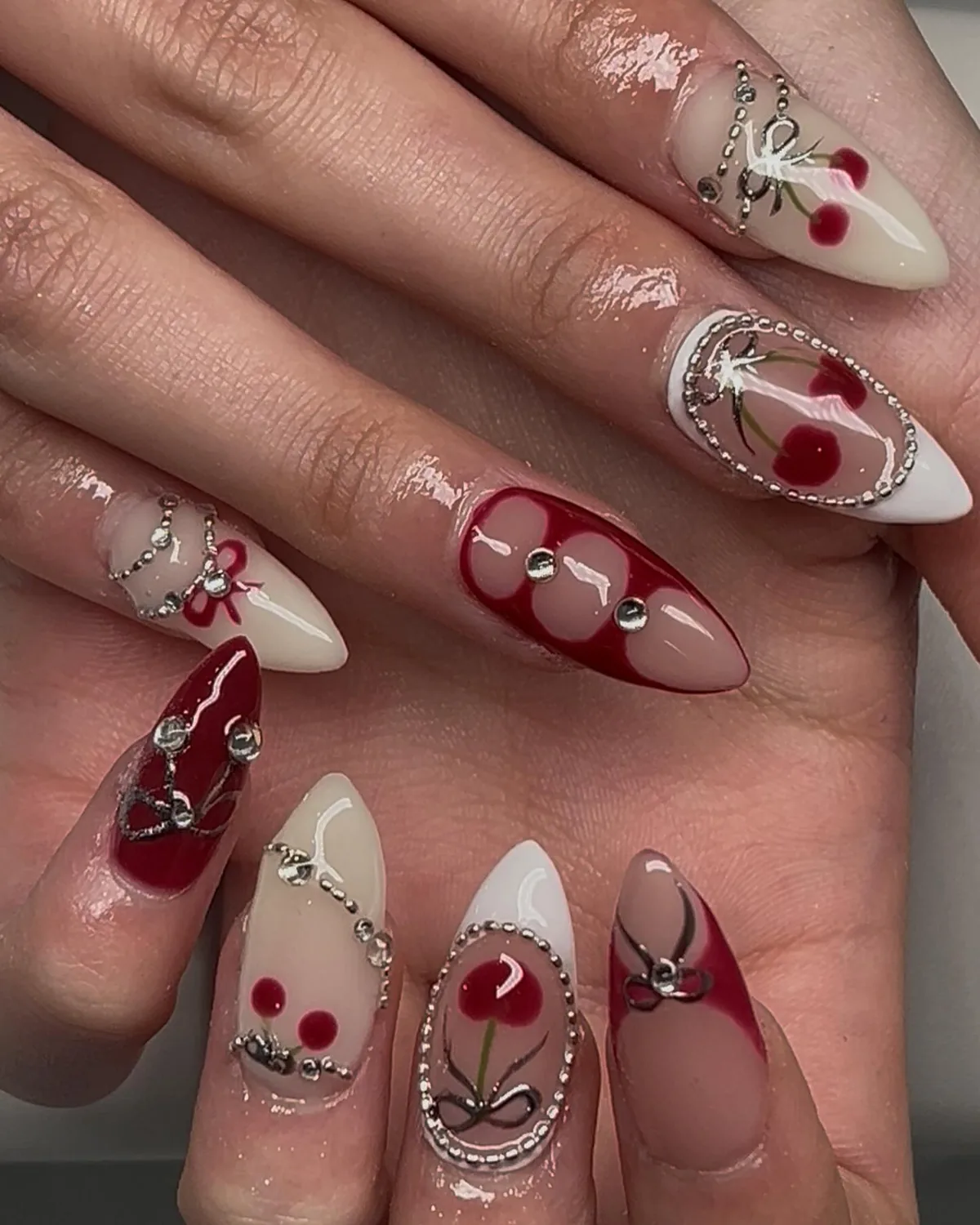 Cream and red stilettos with painted cherries, a cherry charm and silver chrome