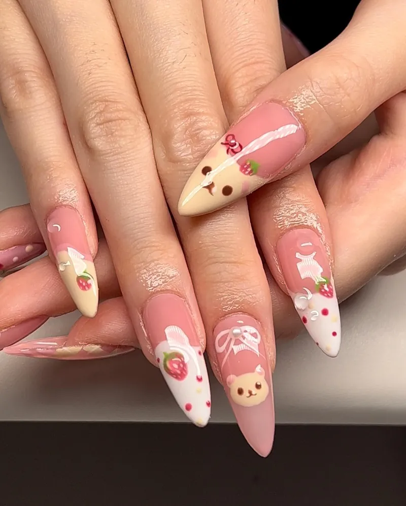 Pink and cream almond nails with Korilakkuma faces, strawberries and bows