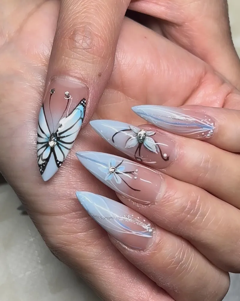 Pale blue ombre stilettos with a painted butterfly and fine liner
