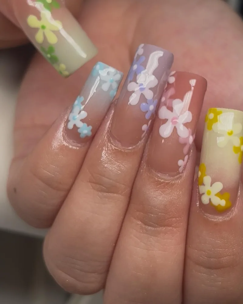 Long square nails with hand-painted pastel flowers, a simple tier set
